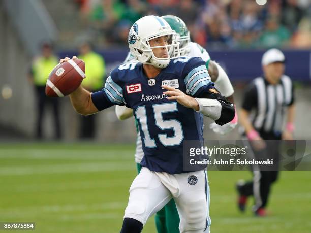 Ricky Ray of the Toronto Argonauts goes to pass while getting pressure from the Saskatchewan Roughriders during a game at BMO field on October 7,...