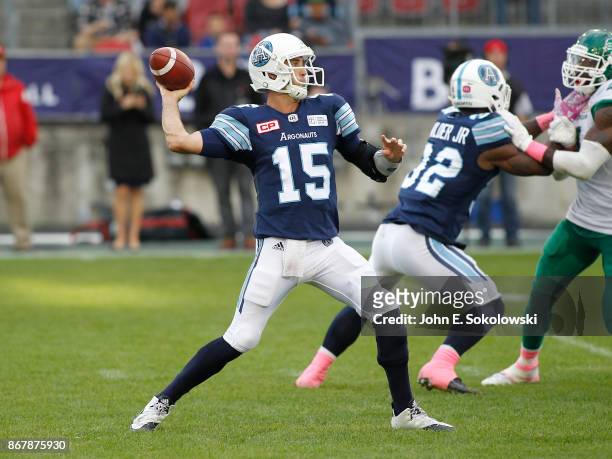 Ricky Ray throws a pass as James Wilder Jr. #32 of the Toronto Argonauts blocks against the Saskatchewan Roughriders during a game at BMO field on...