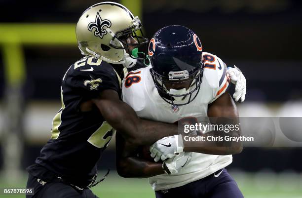 Tre McBride of the Chicago Bears is tackled by Ken Crawley of the New Orleans Saints during the third quarter at the Mercedes-Benz Superdome on...