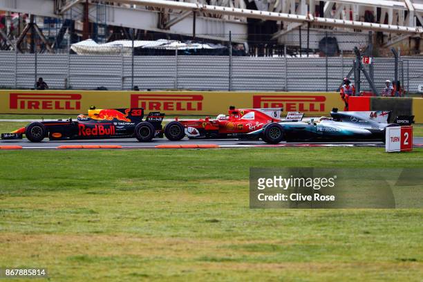 Max Verstappen of the Netherlands driving the Red Bull Racing Red Bull-TAG Heuer RB13 TAG Heuer, Sebastian Vettel of Germany driving the Scuderia...