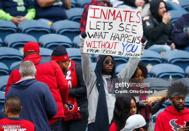 Houston Texans fan holds a sign referring to Houston Texans owner Bob McNair's "inmates" comments before a game between the Houston Texans and...