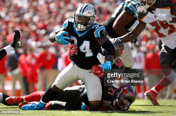 Running back Cameron Artis-Payne of the Carolina Panthers is brought down by middle linebacker Kwon Alexander of the Tampa Bay Buccaneers and strong...