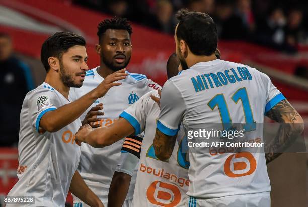 Marseille's French midfielder Morgan Sanson celebrates after scoring a goal with Marseille's Cameroonian midfielder Andre Zambo Anguissa and others...