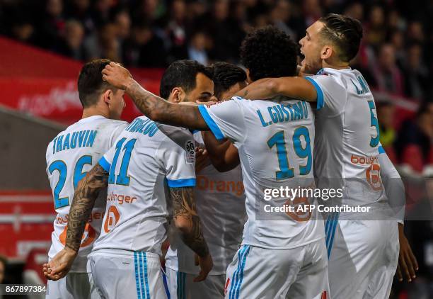 Marseille's players celebrate a goal by French midfielder Morgan Sanson during the French L1 football match between Lille OSC and Olympique de...