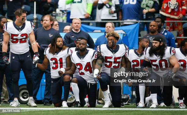 Members of the Houston Texans stand and kneel before the game against the Seattle Seahawks at CenturyLink Field on October 29, 2017 in Seattle,...