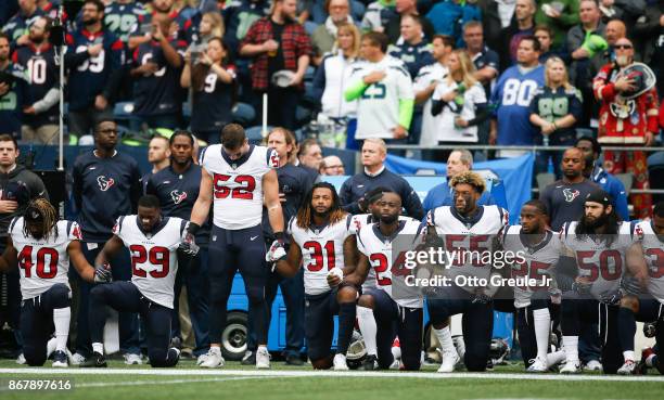 Members of the Houston Texans stand and kneel before the game against the Seattle Seahawks at CenturyLink Field on October 29, 2017 in Seattle,...