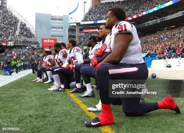 Members of the Houston Texans kneel during the national anthem before the game against the Seattle Seahawks at CenturyLink Field on October 29, 2017...