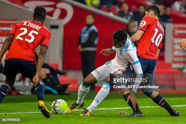 Marseille's Cameroonian midfielder Andre Zambo Anguissa vies with Lille's French forward Yassine Benzia during the French L1 football match between...