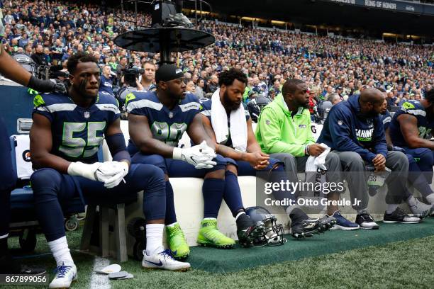 Members of the Seattle Seahawks sit on the bench during the national anthem, including Frank Clark, Jarran Reed, Michael Bennett and Cliff Avril,...