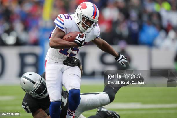 Brandon Tate of the Buffalo Bills runs with the ball as Bruce Irvin of the Oakland Raiders attempts to tackle him during the third quarter of an NFL...