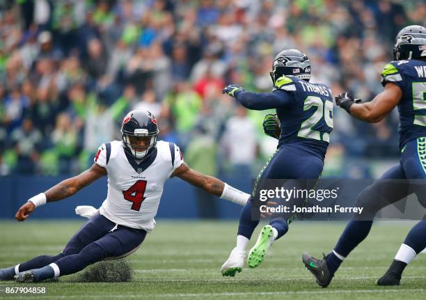 Quarterback Deshaun Watson of the Houston Texans tries to tackle free safety Earl Thomas of the Seattle Seahawks as Thomas returns an interception...