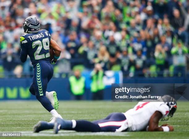 Free safety Earl Thomas of the Seattle Seahawks makes it past quarterback Deshaun Watson of the Houston Texans to return an interception for a...