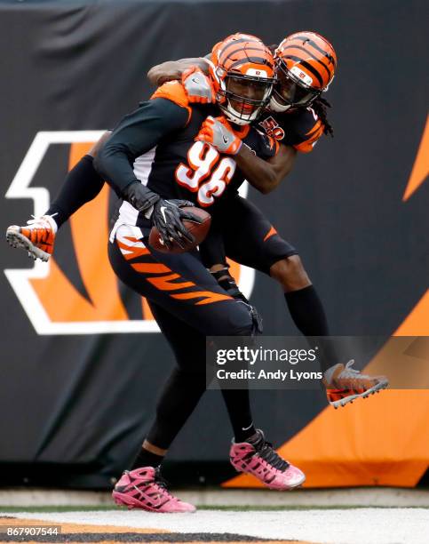 Carlos Dunlap and Dre Kirkpatrick of the Cincinnati Bengals celebrate after Dunlap returned an interception for a touchdown against the Indianapolis...