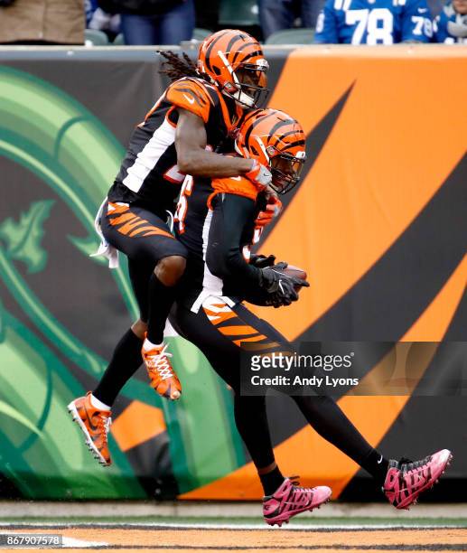Carlos Dunlap and Dre Kirkpatrick of the Cincinnati Bengals celebrate after Dunlap returned an interception for a touchdown against the Indianapolis...