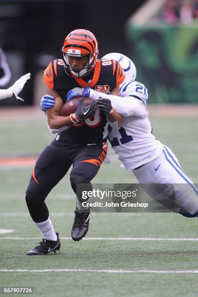 Josh Malone of the Cincinnati Bengals runs the football upfield against Vontae Davis of the Indianapolis Colts during their game at Paul Brown...