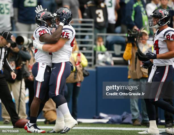 Running back Lamar Miller of the Houston Texans celebrates his 3 yard touchdown with Jay Prosch during the first quarter of the game against the...