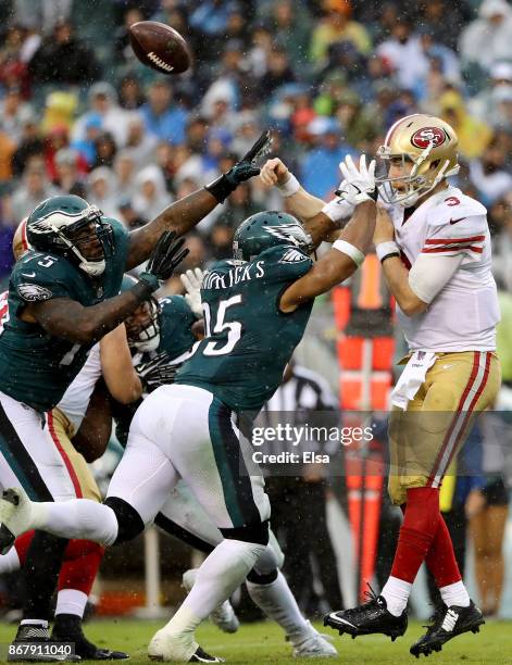 Beathard of the San Francisco 49ers is pressured by Vinny Curry and Mychal Kendricks of the Philadelphia Eagles in the second half on October 29,...