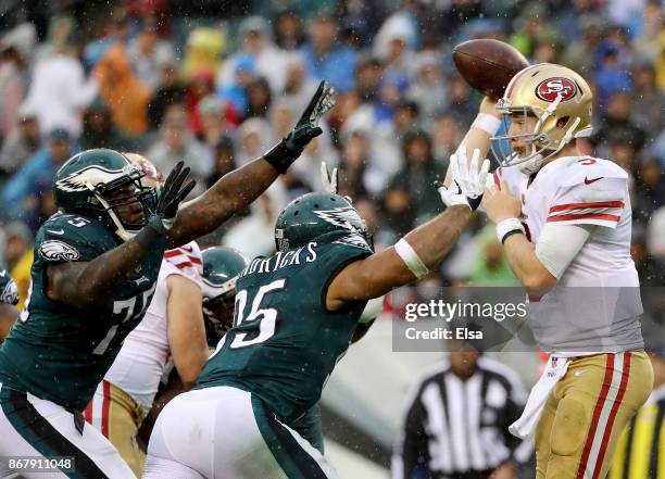 Beathard of the San Francisco 49ers is pressured by Vinny Curry and Mychal Kendricks of the Philadelphia Eagles in the second half on October 29,...