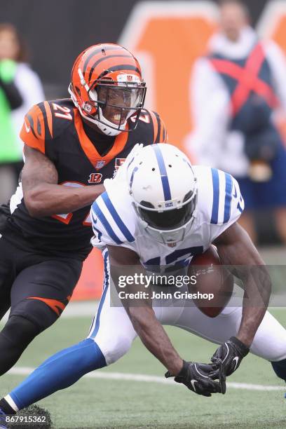 Darqueze Dennard of the Cincinnati Bengals jars the football loose from T.Y. Hilton of the Indianapolis Colts during their game at Paul Brown Stadium...