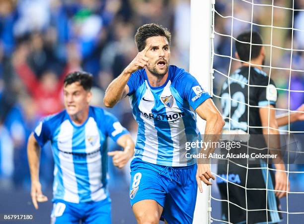 Adrian Gonzalez of Malaga CF celebrates after scoring the first goal for Malaga of CF during the La Liga match between Malaga and Celta de Vigo at...