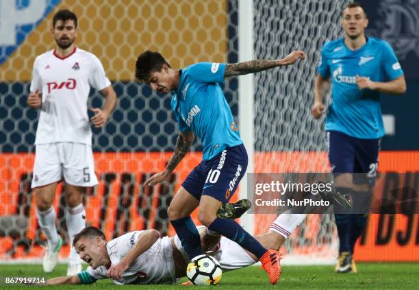 Igor Denisov of FC Lokomotiv Moskva and Emiliano Rigoni of FC Zenit Saint Petersburg vie for the ball during the Russian Football League match...