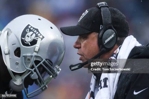 Reggie Nelson of the Oakland Raiders listens as head coach Jack Del Rio of the Oakland Raiders talks to him during the first quarter of an NFL game...