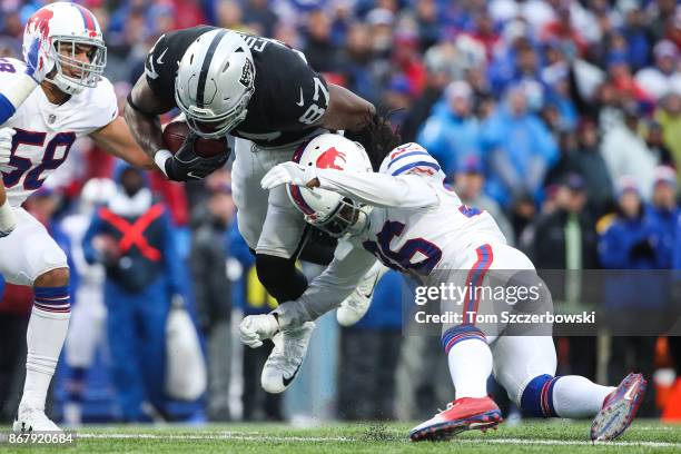 Jared Cook of the Oakland Raiders is tackled by Trae Elston of the Buffalo Bills during the fourth quarter of an NFL game on October 29, 2017 at New...