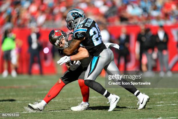 Tampa Bay Buccaneers tight end Cameron Brate is tackled by Carolina Panthers safety Kurt Coleman after a reception during the second half of an NFL...