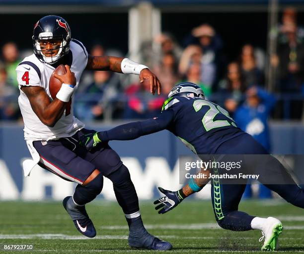 Quarterback Deshaun Watson of the Houston Texans tries to escape free safety Earl Thomas of the Seattle Seahawks during the second quarter of the...