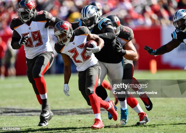 Tampa Bay Buccaneers running back Doug Martin is pursued by Carolina Panthers defensive tackle Vernon Butler during the first half of an NFL football...