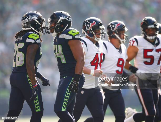 Cornerback Shaquill Griffin of the Seattle Seahawks and Bobby Wagner greet each other during the second quarter of the game against the Houston...