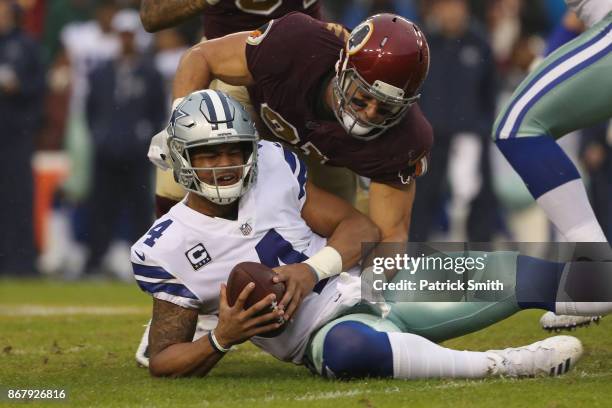 Outside linebacker Ryan Kerrigan of the Washington Redskins sacks quarterback Dak Prescott of the Dallas Cowboys during the second quarter at FedEx...