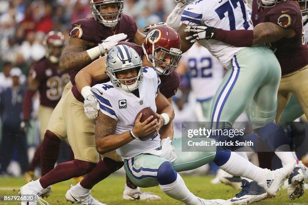 Outside linebacker Ryan Kerrigan of the Washington Redskins sacks quarterback Dak Prescott of the Dallas Cowboys during the second quarter at FedEx...