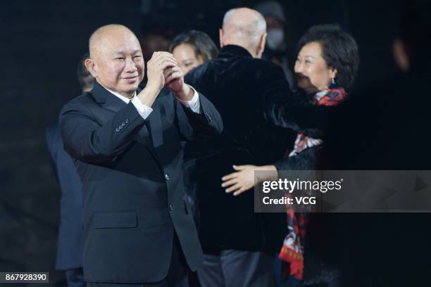 Director John Woo arrives at the red carpet of the 1st Pingyao Crouching Tiger Hidden Dragon International Film Festival at Pingyao County on October...