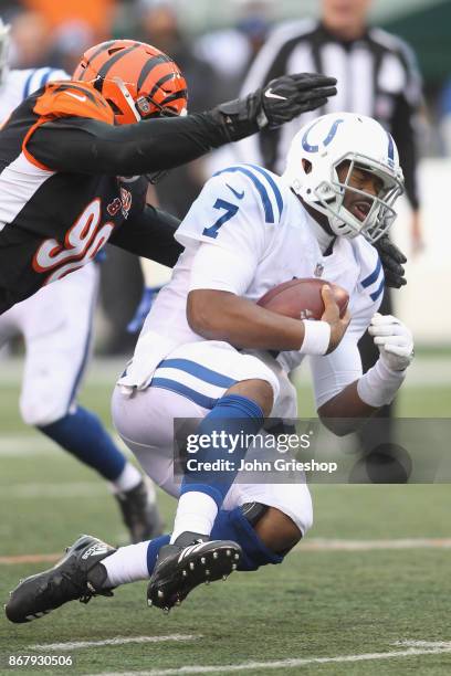 Jacoby Brissett of the Indianapolis Colts slides to avoid the pressure of Carlos Dunlap of the Cincinnati Bengals during their game at Paul Brown...