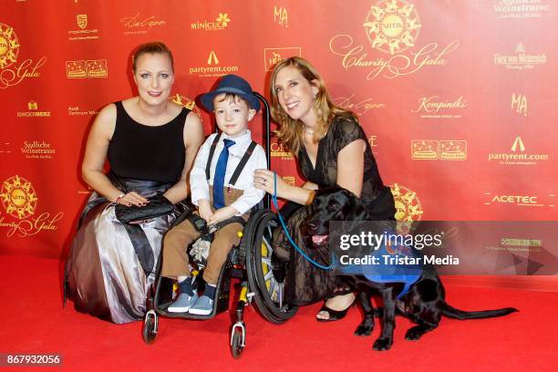 Cathrin Koch , Vita Team Robin Richter with his assistance dog and Susanne Munz during the 8th VITA Charity Gala In Wiesbaden on October 28, 2017 in...