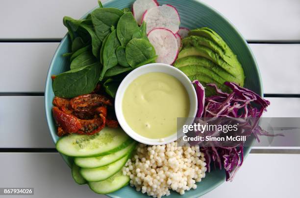 vegan breakfast of pearl couscous and raw vegetables: cucumber, sundried-tomatoes, baby spinach, radish, avocado, and red cabbage with aioli - aioli bildbanksfoton och bilder