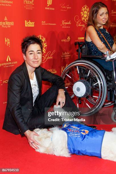 German presenter Dunja Hayali with an assistance dog during the 8th VITA Charity Gala In Wiesbaden on October 28, 2017 in Wiesbaden, Germany.