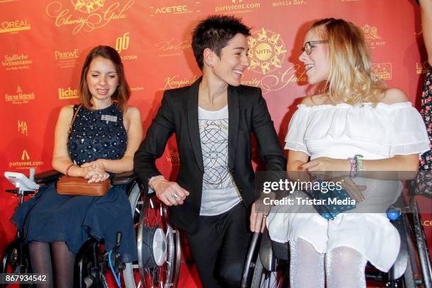 Pauline Bader, German presenter Dunja Hayali and Frieda Krieger during the 8th VITA Charity Gala In Wiesbaden on October 28, 2017 in Wiesbaden,...