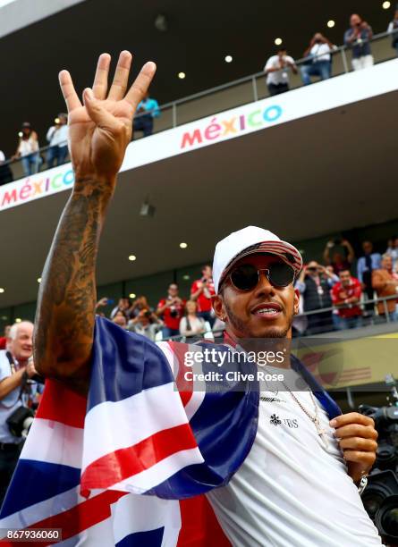 Lewis Hamilton of Great Britain and Mercedes GP celebrates after winning his fourth F1 World Drivers Championship after the Formula One Grand Prix of...