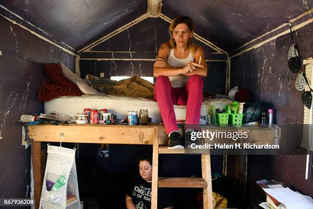 Beloved Community Village residents Silla Wolf, above, and her roommate Kim Grier, relax inside their tiny home at the Beloved Community Village in...
