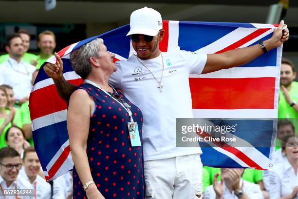 Lewis Hamilton of Great Britain and Mercedes GP celebrates with his mother Carmen Larbalestier after winning his fourth F1 World Drivers Championship...