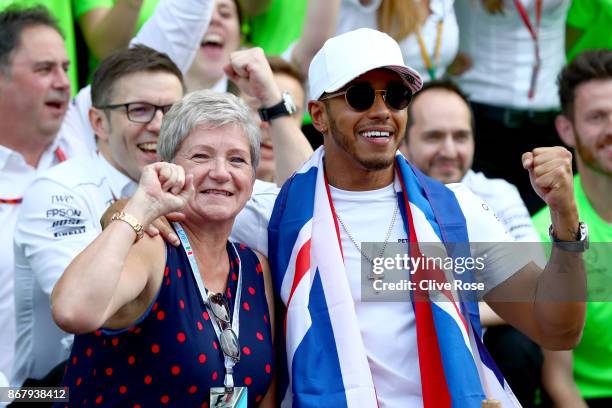 Lewis Hamilton of Great Britain and Mercedes GP celebrates with his mother Carmen Larbalestier after winning his fourth F1 World Drivers Championship...
