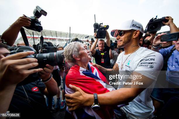 Lewis Hamilton of Mercedes and Great Britain celebrates becoming the 2017 Formula One Drivers World Champion with his Mother Carmen during the...