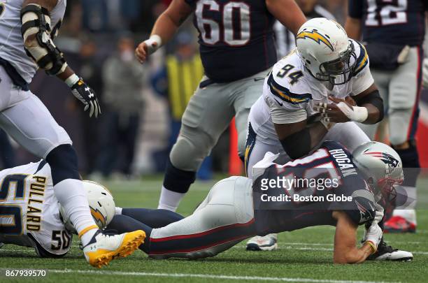 New England Patriots wide receiver Chris Hogan lands on his right arm as he is tackled by the Chargers Hayes Pullard and Corey Liuget in the fourth...