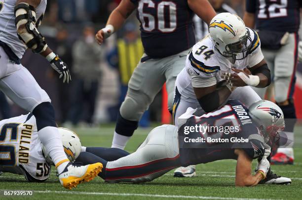 New England Patriots wide receiver Chris Hogan lands on his right arm as he is tackled by the Chargers Hayes Pullard and Corey Liuget in the fourth...