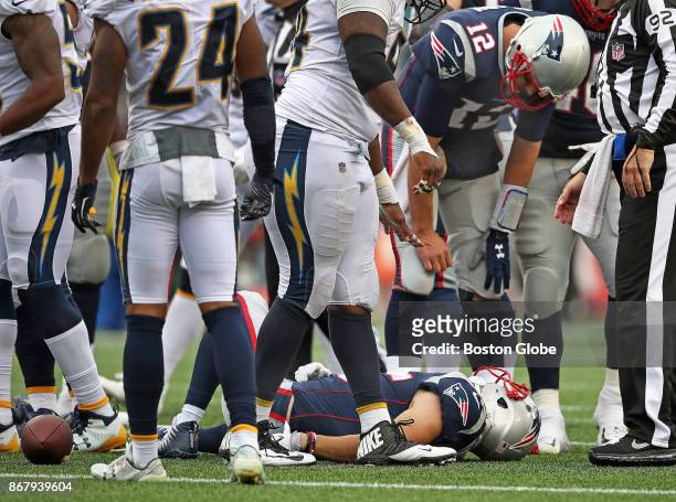 New England Patriots quarterback Tom Brady checks on the condition of wide reciever Chris Hogan after he was injured in the fourrh quarter. He left...