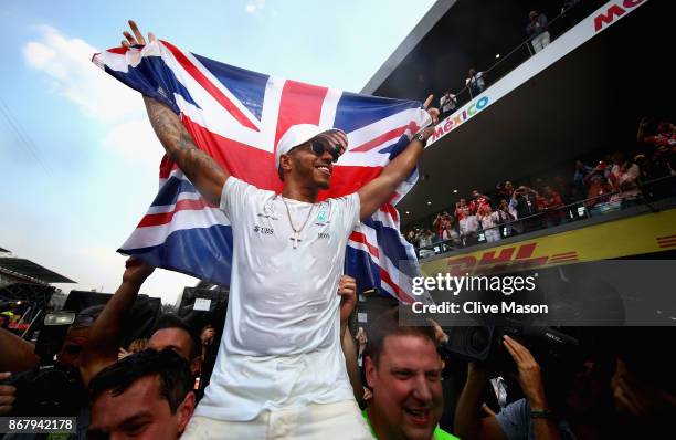 Lewis Hamilton of Great Britain and Mercedes GP celebrates after winning his fourth F1 World Drivers Championship after the Formula One Grand Prix of...