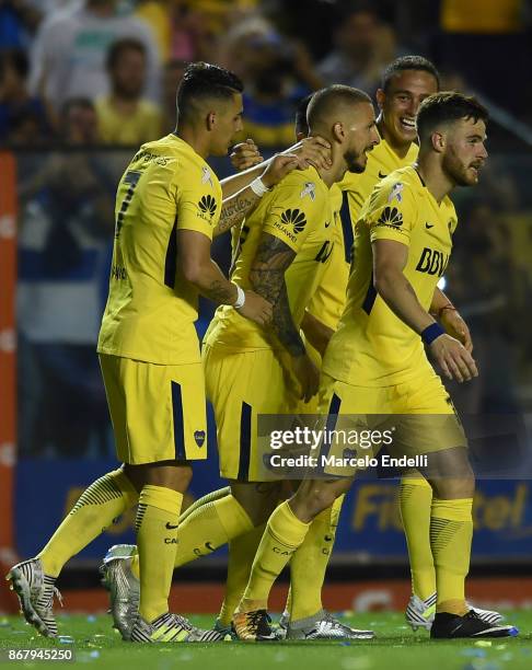 Dario Benedetto of Boca Juniors celebrates with teammates after scoring the fourth goal of his team during a match between Boca Juniors and Belgrano...