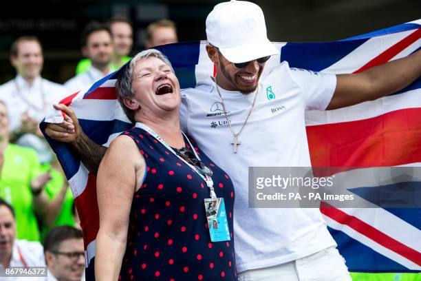Mercedes' Lewis Hamilton celebrates winning the Formula One drivers' championship with him mum Carmen Larbalestier after the Mexican Grand Prix at...